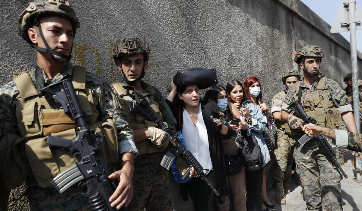 Lebanese teachers react to the sounds from nearby armed clashes